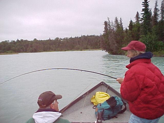 Our very first WA steelhead guest years ago provides a little coaching as his wife Lynn does battle with a Kasilof River silver