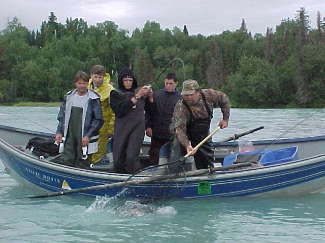 Guide Dean Swerin puts the net to an August silver salmon.