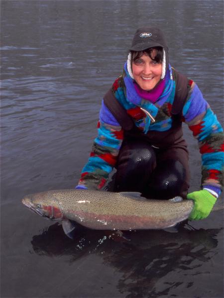 Kimmy with a trophy steelhead landed on a snowy Super Bowl Sunday.