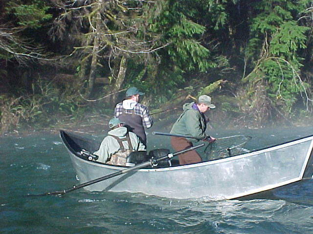 Guide Gordy with fish in net prepares to pull it in.