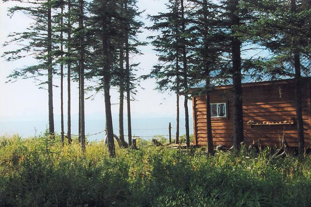 An exterior view of the cabin at Ocean Bluff overlooking Cook Inlet and the numerous volcanic peaks to 10,000+ feet on it's far