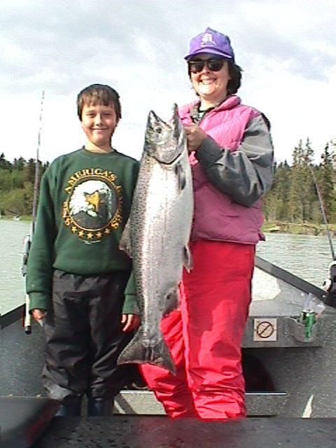 Mom give Hunter a hand with his first-ever king salmon.