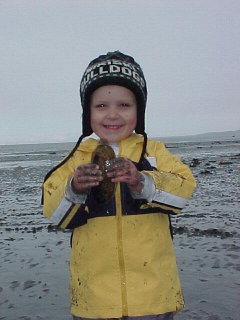 A young digger shows off his prized raor clam!